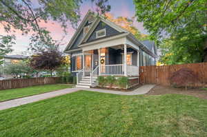 View of front of property featuring a yard and covered porch