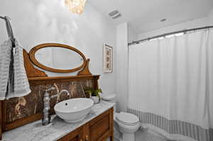 Bathroom with vanity, toilet, and tile patterned flooring