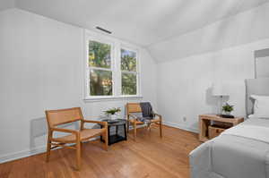 Bedroom featuring vaulted ceiling and light hardwood / wood-style flooring