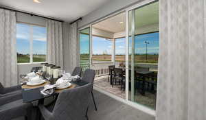 Dining area featuring LVT flooring. Covered patio has not been selected for this house.This is a picture of the model home; selections and colors may vary.