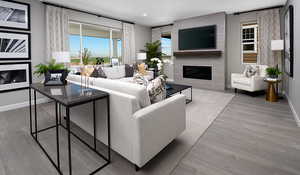 Living room featuring LVT flooring, and lots of natural light. Fireplace and the extra windows to the side of the fireplace have not been selected for this house.This is a picture of the model home; selections and colors may vary.