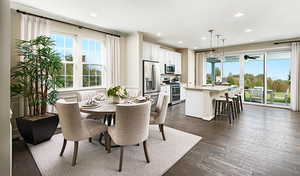 Dining room featuring sink, LVT flooring and lots of natural light.Materials and colors may vary; this pictures is of a model home.