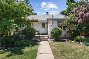 Bungalow-style house featuring a front lawn