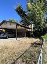 View of side of home with a carport