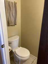 Bathroom featuring toilet and tile patterned floors