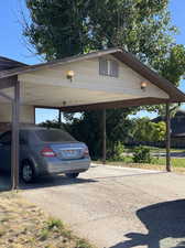 View of parking with a carport