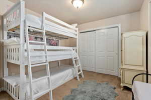 Bedroom featuring a closet and carpet flooring