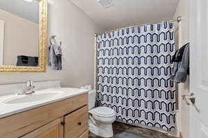 Bathroom with tile patterned floors, vanity, and toilet