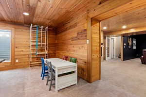 Office space featuring light carpet and wooden ceiling