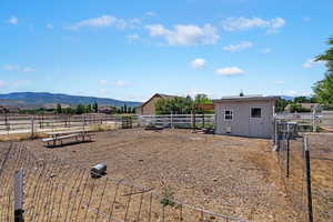 Barnyard animal area. View of yard featuring , a mountain view, and a rural view