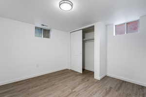 Unfurnished bedroom with wood-type flooring and a closet