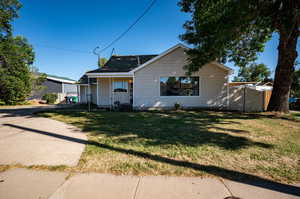 Bungalow-style house featuring a front lawn