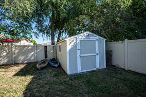 View of outdoor structure with a lawn