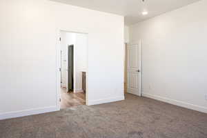 Unfurnished bedroom with light colored carpet