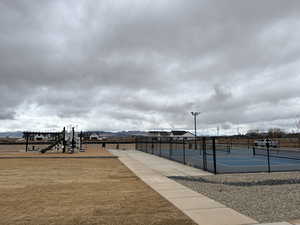 View of home's community featuring tennis court and a playground
