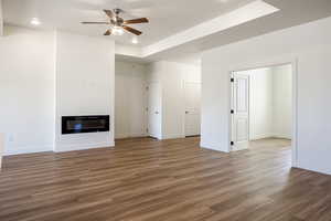 Unfurnished living room with ceiling fan and light wood-type flooring