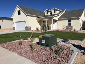View of front of house with a garage and a front yard