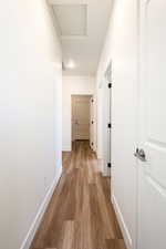 Corridor featuring light wood-type flooring