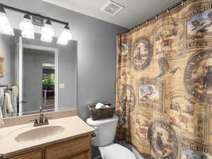 Bathroom with vanity, toilet, and a textured ceiling