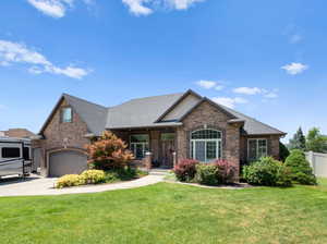 View of front of home with a garage and a front yard