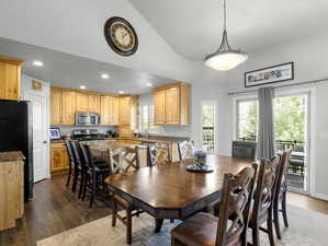 Dining room with a healthy amount of sunlight, dark hardwood / wood-style flooring, and sink