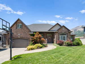 View of front facade with a mountain view and a front yard