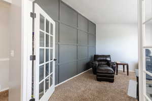 Living area featuring french doors and carpet floors