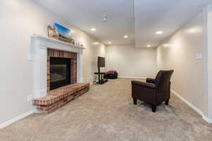 Carpeted living room featuring a fireplace