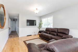 Living room with light hardwood / wood-style flooring