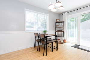 Dining space with light hardwood / wood-style flooring