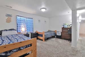 Bedroom featuring light carpet