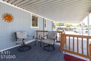 Covered deck, carpeted with roll down shade.