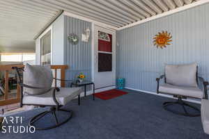 Covered deck, carpeted with roll down shade.