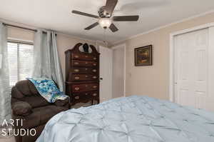 Bedroom featuring ornamental molding, a closet, and ceiling fan