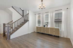 Interior space with wood-type flooring and an inviting chandelier