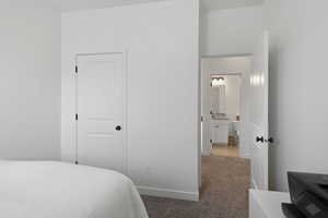 Carpeted bedroom featuring a closet and connected bathroom