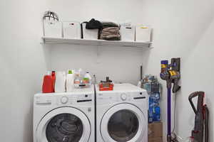 Clothes washing area featuring washer and dryer