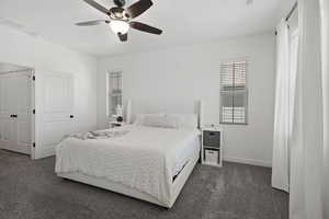 Bedroom featuring dark carpet and ceiling fan