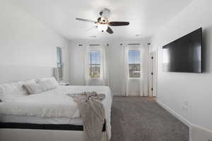 Carpeted bedroom featuring ceiling fan