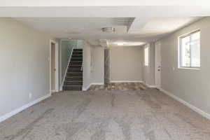 Interior space featuring carpet floors and a textured ceiling