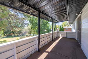 View of patio with a balcony