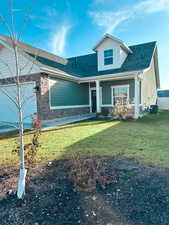 View of front of house with cooling unit, a garage, and a front yard