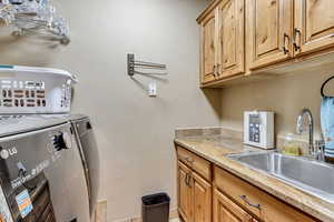 Laundry room with sink and cabinets