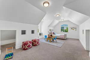 Large bonus room/bedroom featuring vaulted ceiling.