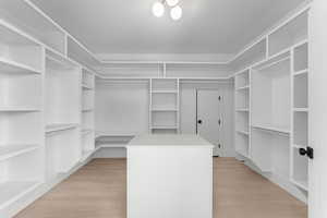 Spacious walk-in closet with locking safe room in back.