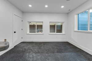 Exercise room with drinking fountain, padded floor and windows over looking sport court.