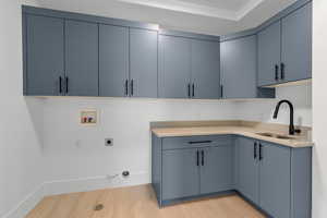 Large laundry room with sink and storage.