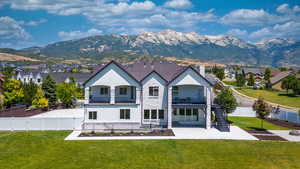 Aerial view of property featuring a mountain view, a balcony, and a patio.