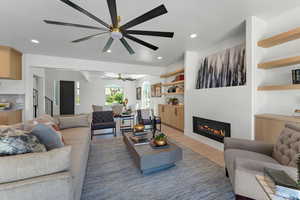 Family room with built in shelves/cabinets and fireplace.