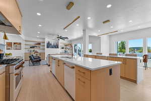 Open floor plan kitchen featuring double islands, quartzite counter tops and 6 burner gas range.